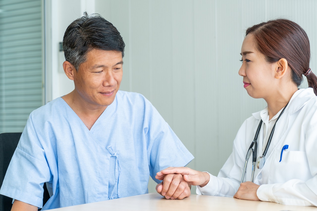 An old asian man having a doctor's appointment pre-surgery