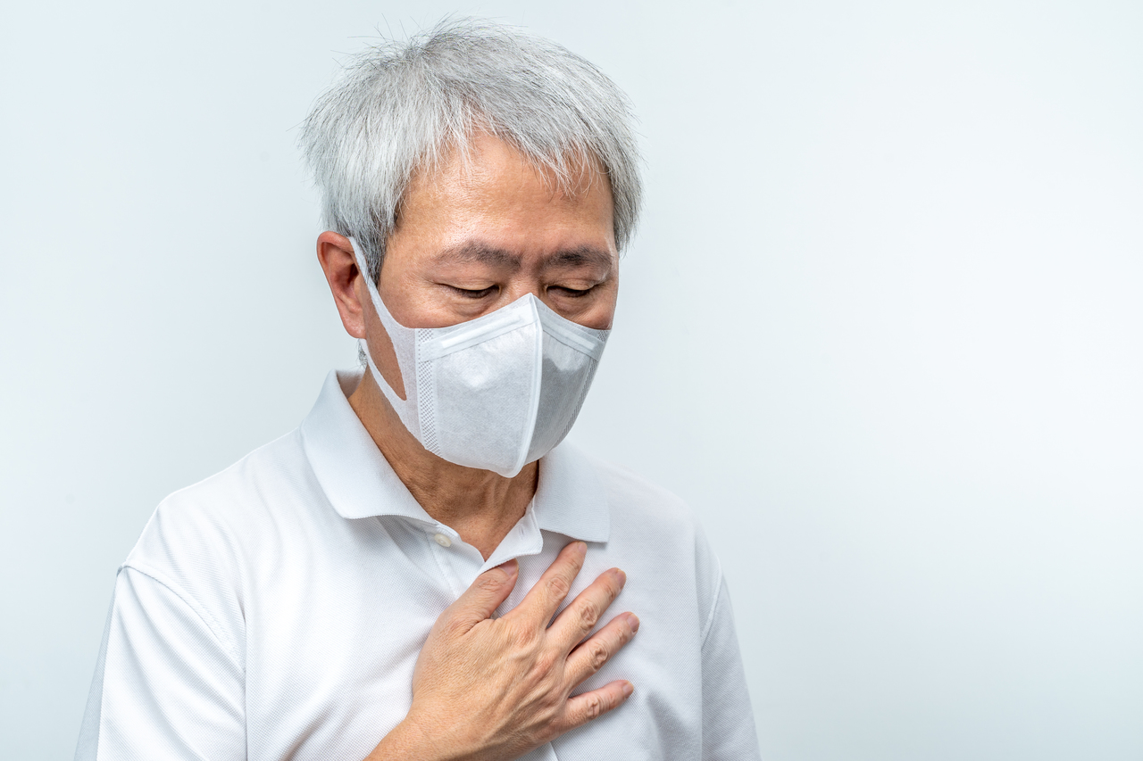 An old man with COVID-19 wearing a face mask