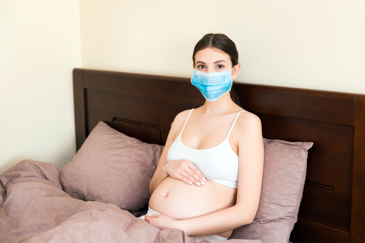 A young pregnant woman at home