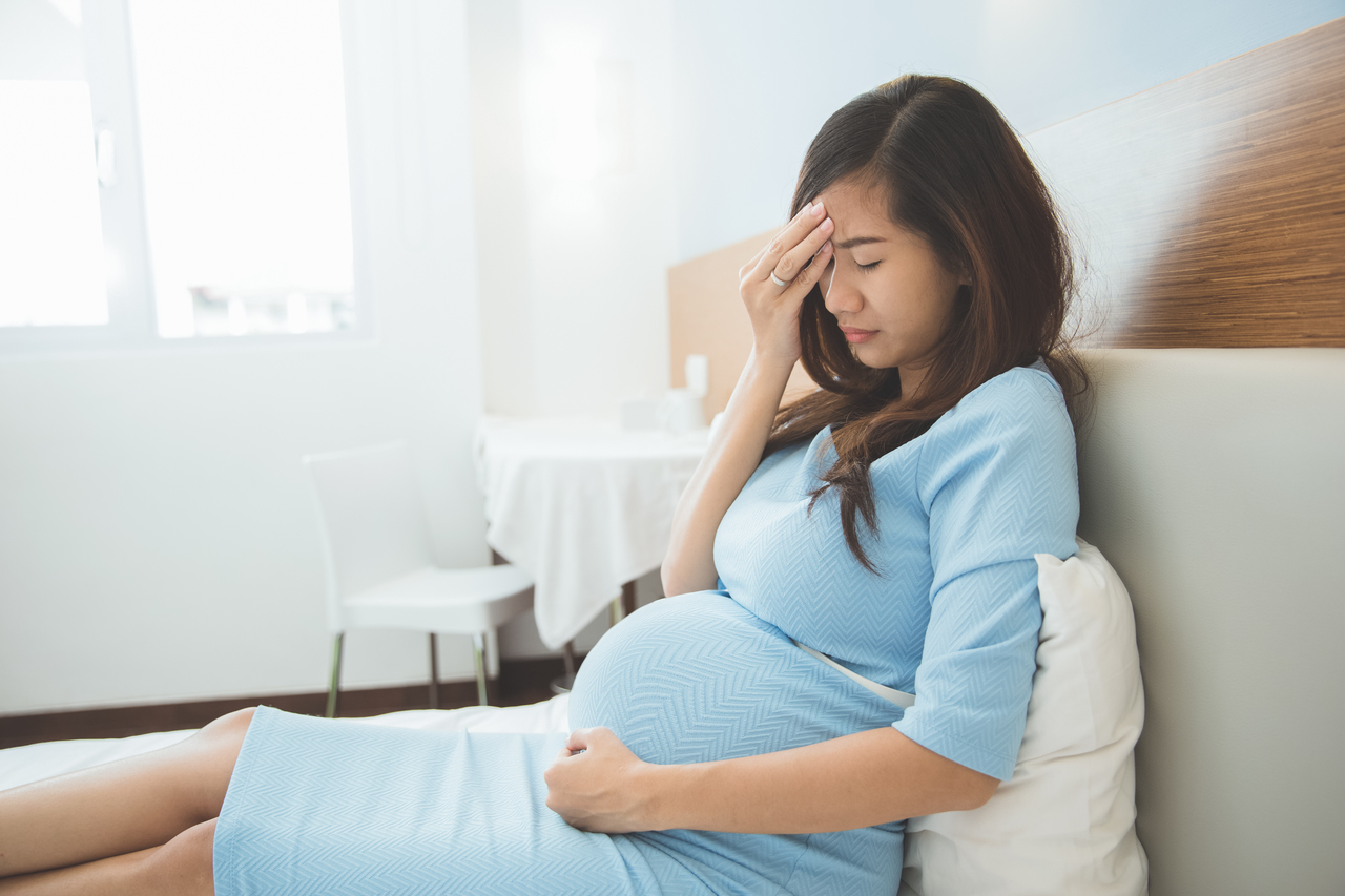 A pregnant woman feeling sick