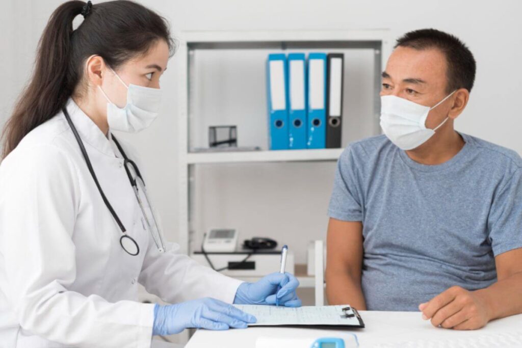 Man consulting with a doctor during a checkup.